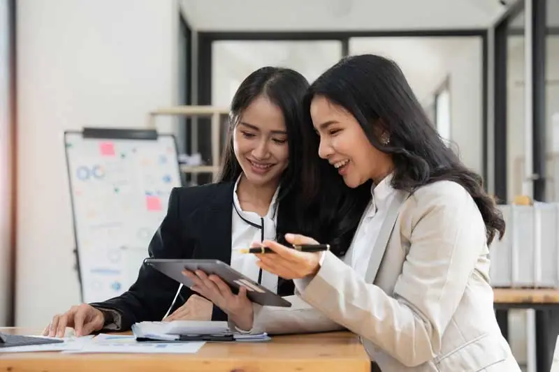 two-young-asian-businesswoman-discuss-investment